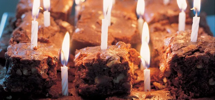 brownies on a plate with candles in them